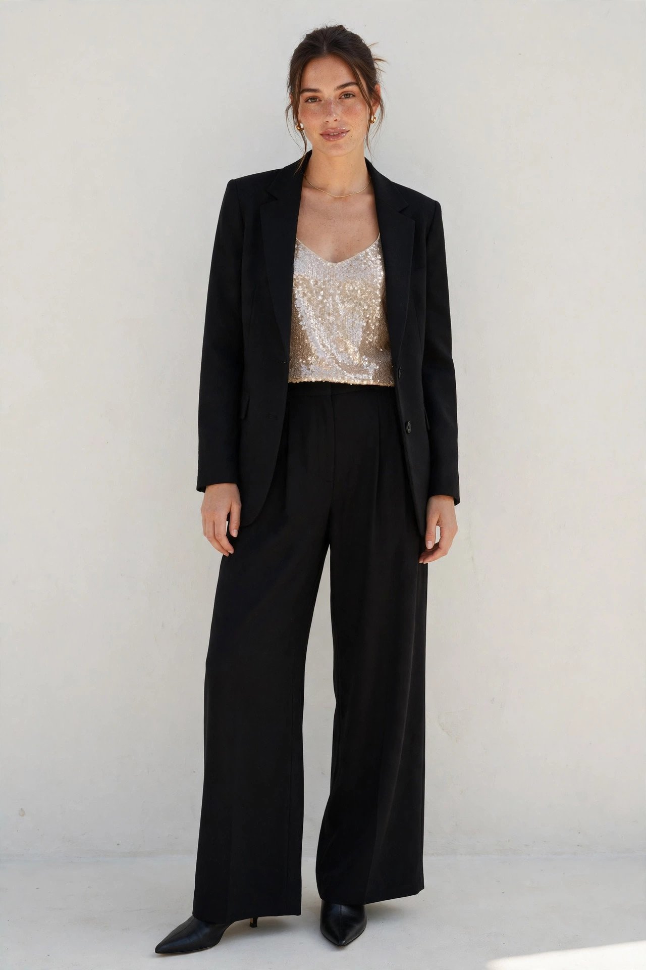fall wedding guest outfits - champagne sequin top and black wide-leg pants