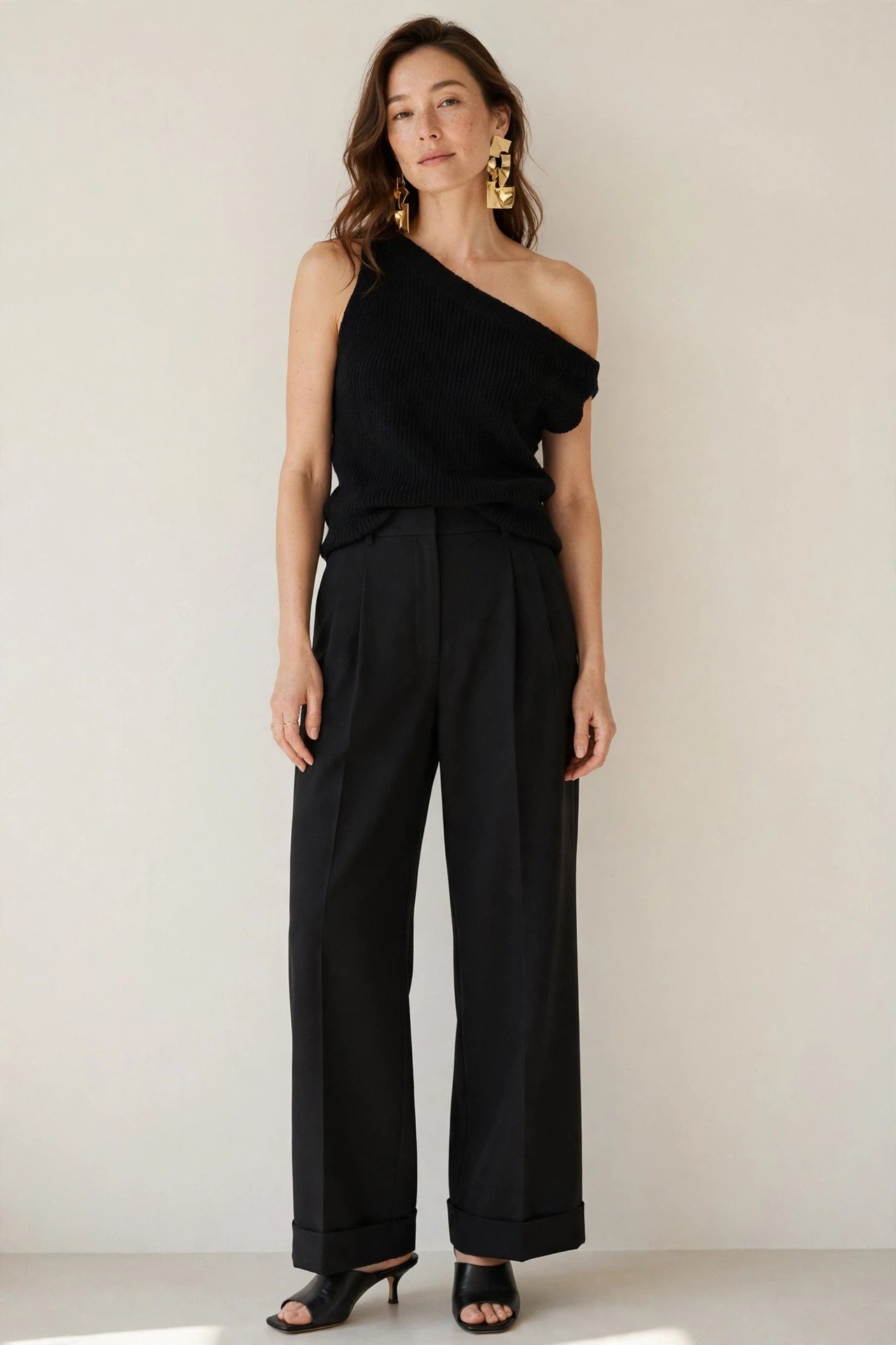 winter date night outfits - one-shoulder black top and wide-leg trousers